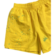 Sp5der yellow athletic shorts featuring a green embroidered logo and a stylish five-star print for performance wear.