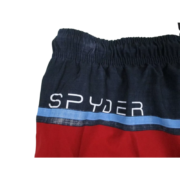 Close-up view of the Spyder logo design detail on these men's swim trunks and board shorts featuring blue and red panels.