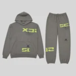 Front view of the slate grey Sp5der 5Ex tracksuit featuring signature web graphics and lime green 5EX text branding.