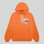 Front view of the Sp5der 5star Rodeo Hoodie in orange, featuring 13oz cotton fleece and a custom distressed chest patch.