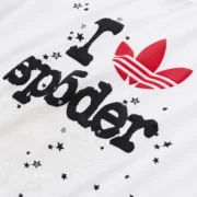Close-up view of the Sp5der x Adidas Souvenir Tee in white, featuring the iconic branded graphic print on the front.