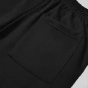 Close-up view of the practical pocket detail on the black Sp5der Angel Number fleece sweatpants for men and women.