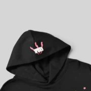 Close-up view of the Sp5der Black Angel Number hoodie, highlighting the signature SP5DER logo print on the hood.