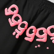 Close-up view of the Sp5der Black Angel Number sweatpants featuring iconic pink puff print 555 graphics on black fleece.