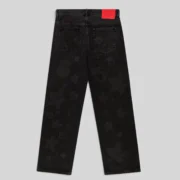 Back view of Sp5der Beluga Denim Black Wash pants featuring a faded vintage aesthetic and red branded leather patch
