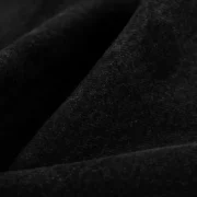 Close-up view of the premium faded black wash fabric texture from the Sp5der Beluga Denim pant collection.