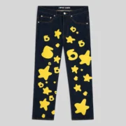 Front view of the Sp5der Beluga Indigo Denim pants featuring a signature yellow 5-star graphic print design.