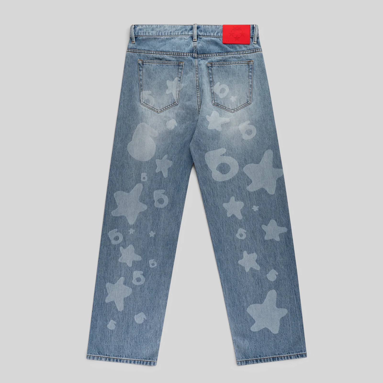 Back view of Sp5der Beluga Denim jeans in Light Blue Wash featuring a faded wash finish and signature print graphics.