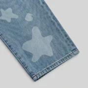 Close-up view of the Sp5der Beluga Denim in Light Blue Wash featuring a faded wash finish and signature print.