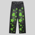 Front view of Sp5der Beluga Stamp Denim in faded black with neon green stamp and star graphic print patterns.