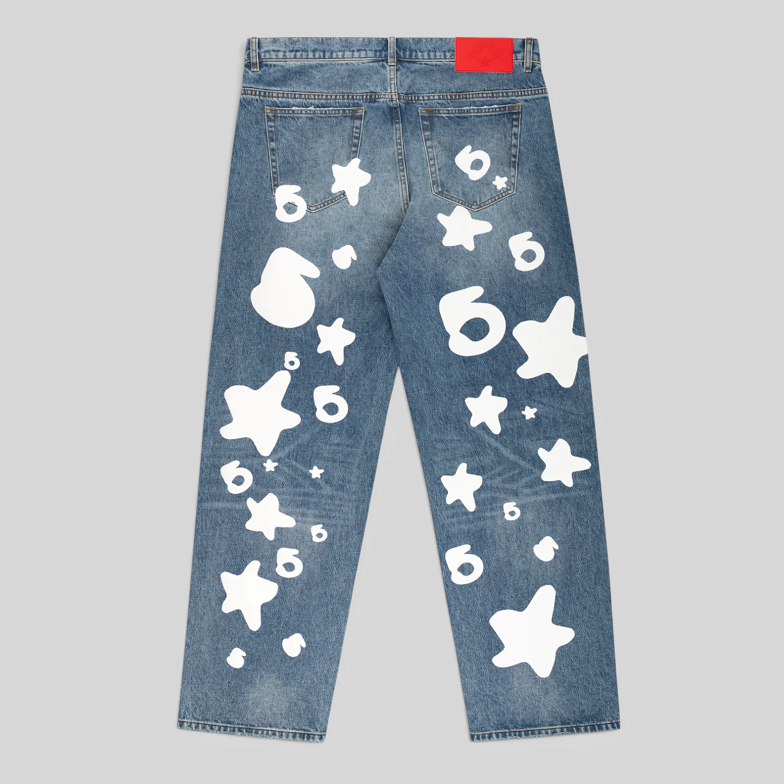 Back view of Sp5der Beluga Wash Denim in Light Indigo, featuring signature white star and graphic logo prints.