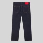 Back view of the premium Sp5der V3 Indigo Denim jeans from the FW24 collection featuring a signature red back patch.