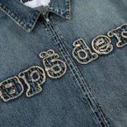 Sp5der Denim Work Jacket in Light Blue Wash featuring a frayed embroidered logo detail on the chest