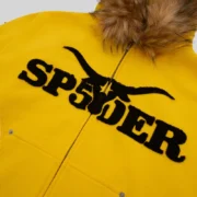 Close-up of the Sp5der Yellow Fur Hooded Zip Up Sweatshirt showing the front logo detail and faux fur hood trim.