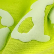 A close-up view of the Acid Green fabric and texture on the Sp5der OG Web V2 sweatshorts with signature print details.