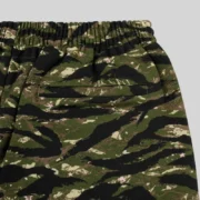 Close up view of the Sp5der OG Web V2 sweatpants in Tiger Camo, showing the detailed pattern and texture of the fabric.