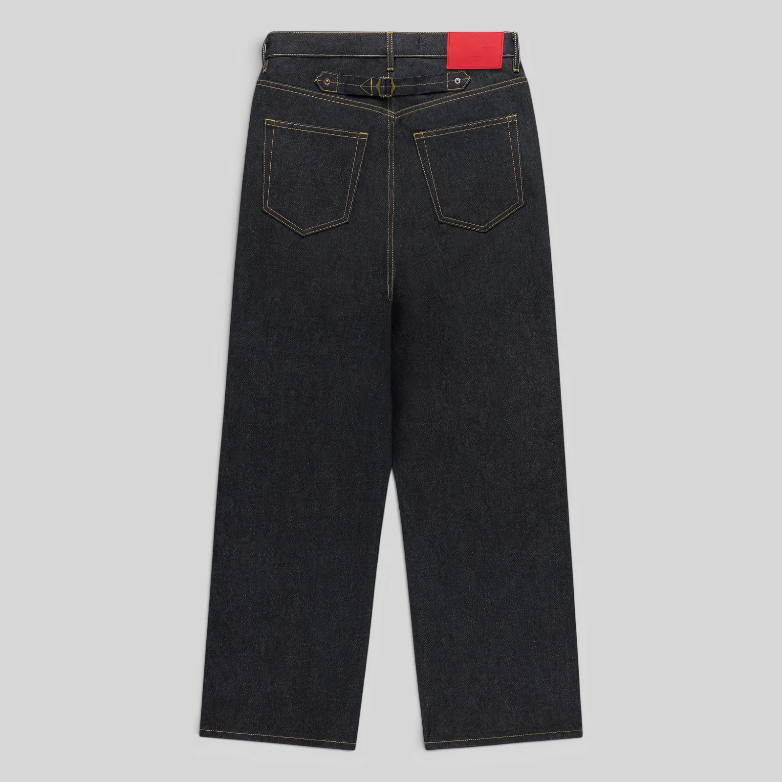 Back view of Sp5der Punk V3 Logo Denim Jeans in Indigo with an adjustable buckle-back cinch and branded leather patch.