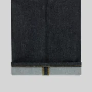 Close-up view of the folded hem detail on the Sp5der Punk V3 Indigo Denim Jeans featuring premium dark wash fabric.