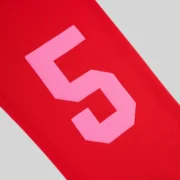 Close up view of the signature pink number 5 motif graphic printed on the back leg of the red Sp5der Stadium sweatpants.