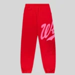 Front view of authentic red Sp5der Stadium sweatpants featuring pink Wait script text and intricate web graphic print.