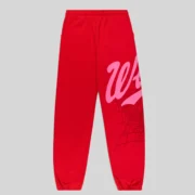Front view of authentic red Sp5der Stadium sweatpants featuring pink Wait script text and intricate web graphic print.