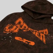 Close-up of the Sp5der T&F Tree Camo Hoodie in Brown featuring premium puff print graphics and heavyweight cotton fleece.