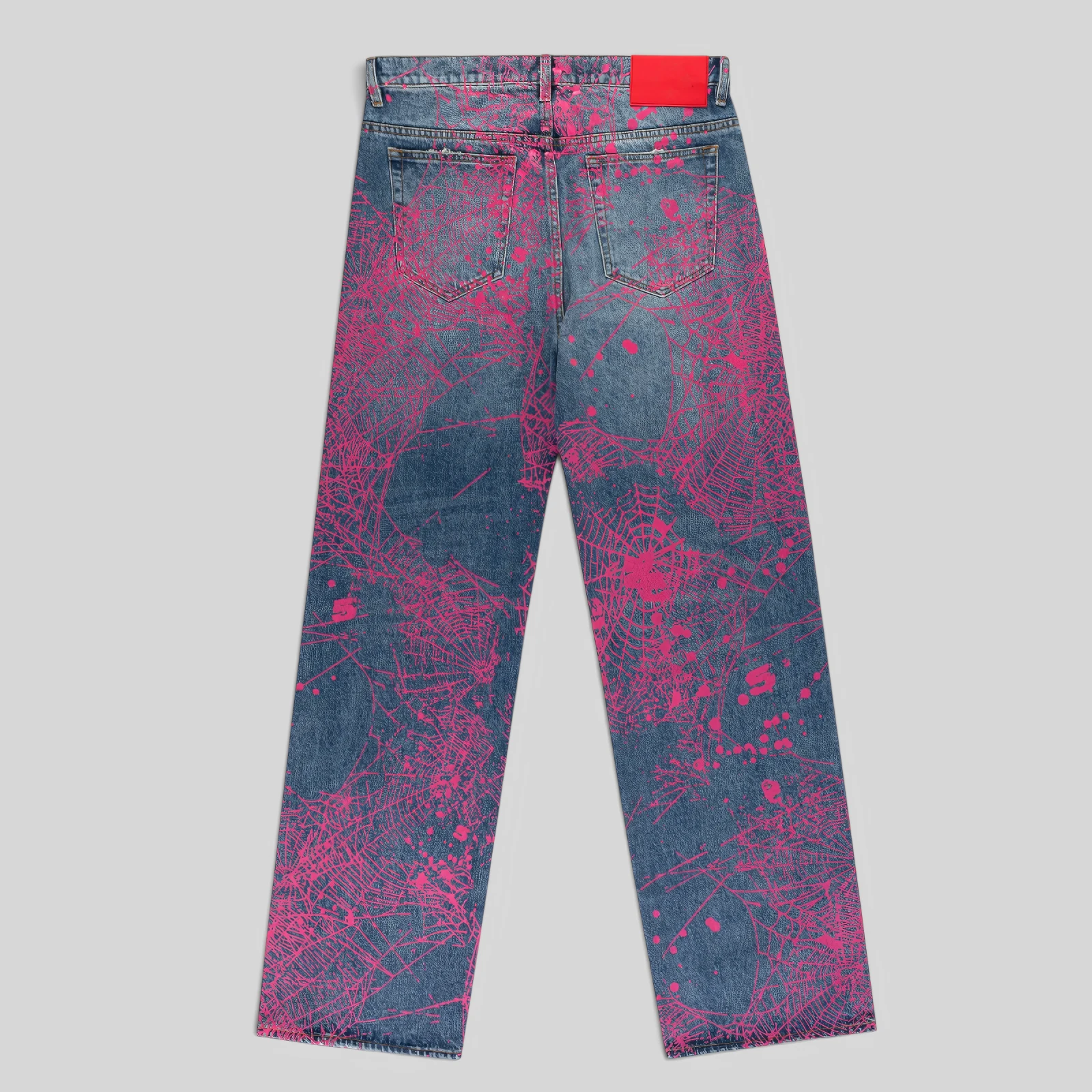 Back view of Sp5der V2 Web Denim in Indigo featuring an all-over pink spider web print and a branded leather waist patch.