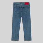 Back view of the Sp5der V3 Indigo Denim Light Wash jeans showing the leather branded patch at the back waistband.