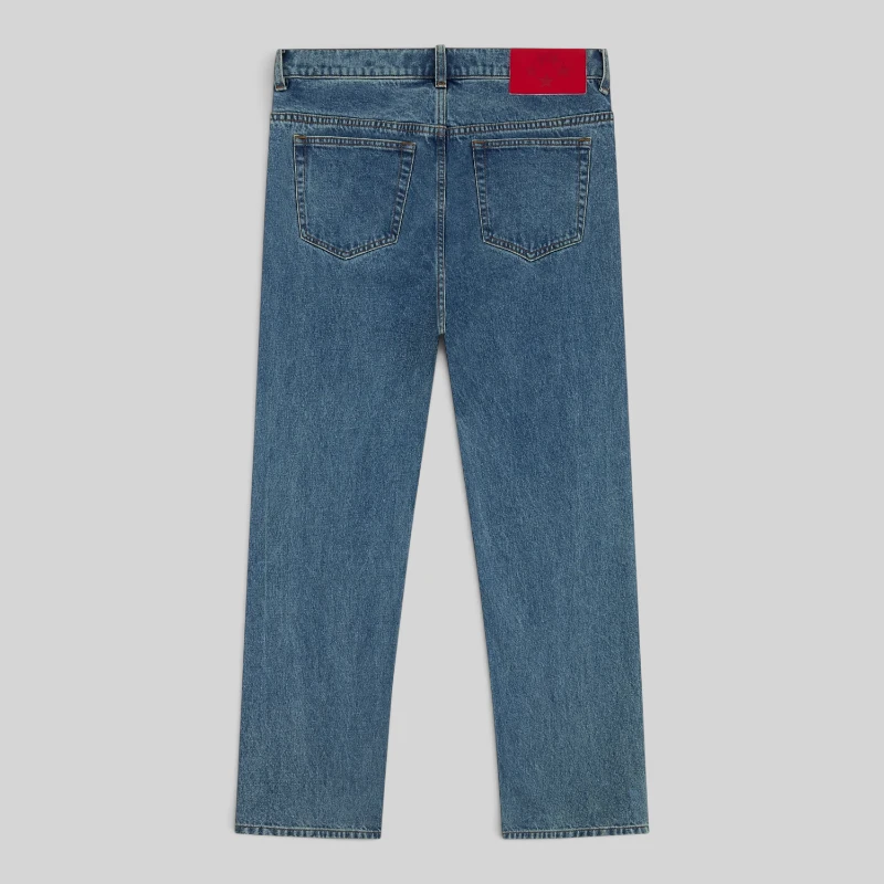 Back view of the Sp5der V3 Indigo Denim Light Wash jeans showing the leather branded patch at the back waistband.