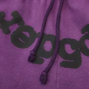 Close-up of the Sp5der Purple Star OG Web V2 sweatpant featuring signature spiderweb graphics and drawstring detail.