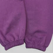 Close-up view of the premium heavyweight purple cotton fleece fabric on the Sp5der Web V2 sweatpants with elastic cuffs